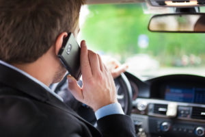 Man talking on the phone while driving his car